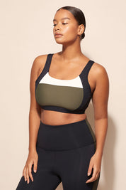 A model wearing the Lay Up Crop in colour Khakiblk (Black), from the front, cropped image