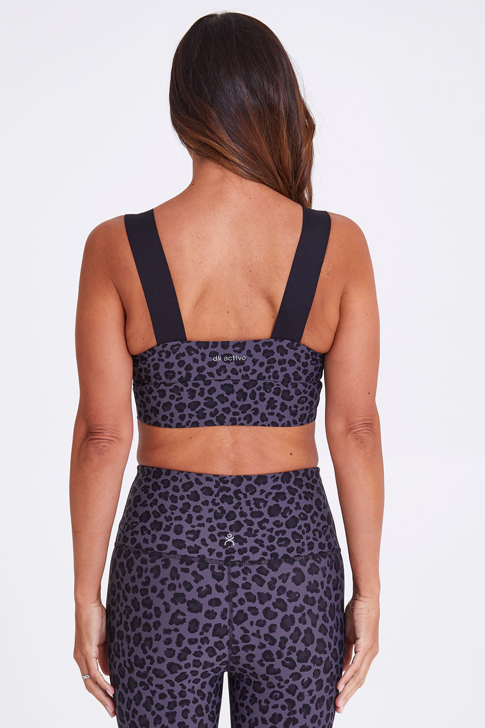 Model Alex wearing the Antidote Crop in colour Leopardsmk (Grey), from the back