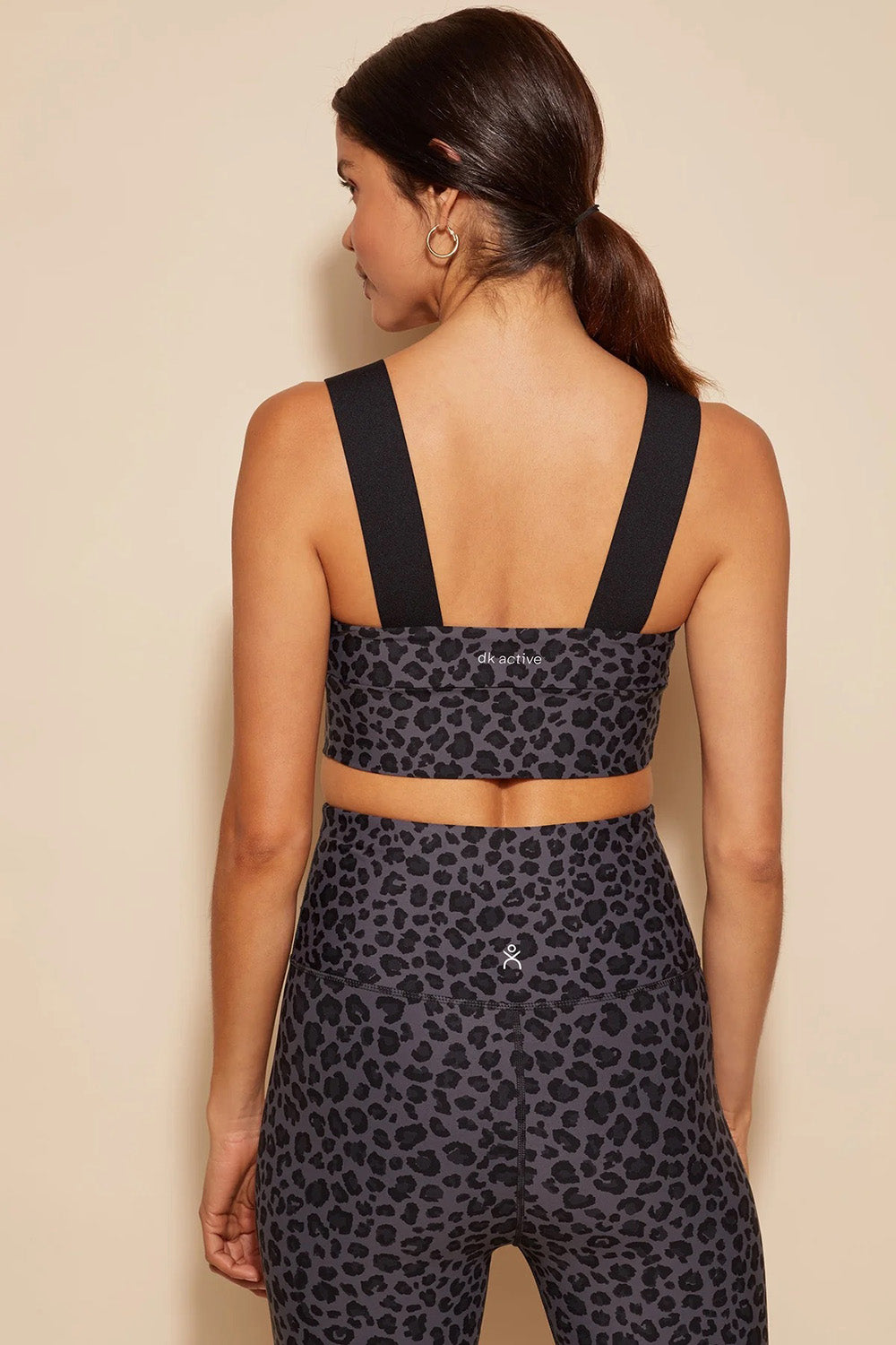 A model wearing the Antidote Crop in colour Leopardsmk (Grey), from the back