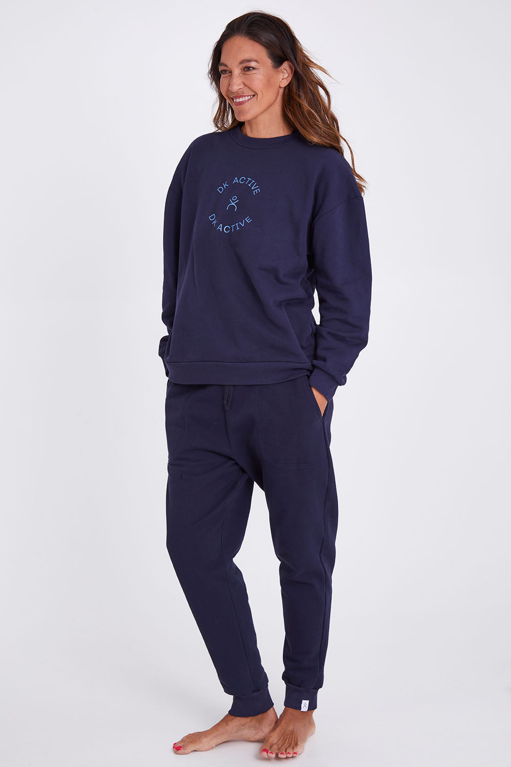Model Alex wearing the Sonny Jumper in colour Navy (Blue), from the front, showing the whole outfit