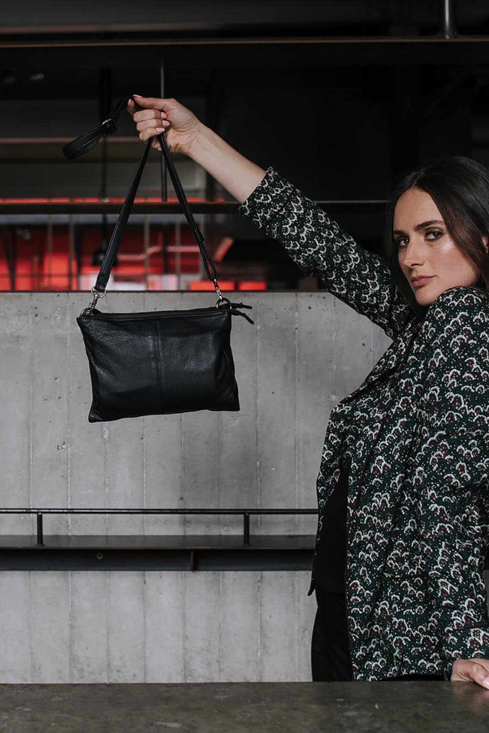 A model wearing the Ellie Leather Bag in colour Black (Black), from the front, showing the whole outfit