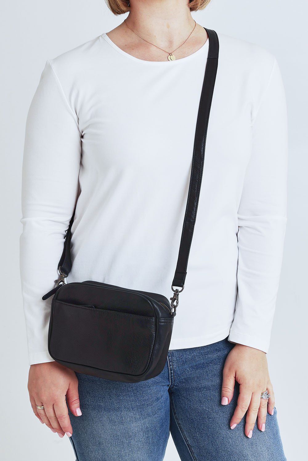 Model Steph wearing size OneSize of the Head In The Clouds Leather Bag in colour Black (Black), from the front, cropped image