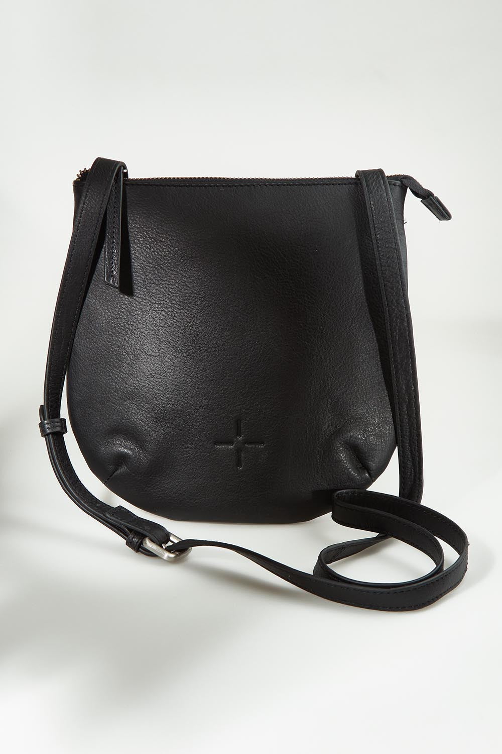 A model wearing the Isabella Crossbody Leather Bag in colour Black (Black), from the front, showing the whole outfit