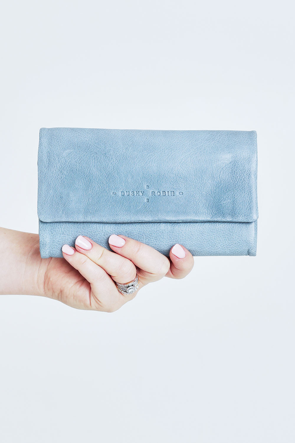 Model Steph wearing size OneSize of the Rose Leather Purse in colour Steelgrey (Grey), from the front, cropped image