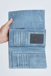 Model Steph wearing size OneSize of the Rose Leather Purse in colour Steelgrey (Grey), from the front, cropped image