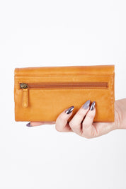 A model wearing size OneSize of the Rose Leather Purse in colour Tan, from the front, showing the whole outfit
