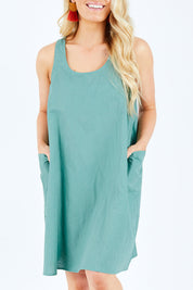 Model Hayley wearing the Serengeti Tank Dress in colour Sage (Green), from the front, cropped image