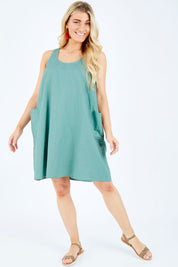 Model Hayley wearing the Serengeti Tank Dress in colour Sage (Green), from the front, showing the whole outfit