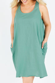Model Jess wearing the Serengeti Tank Dress in colour Sage (Green), from the front, cropped image