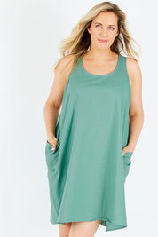 Model Jess wearing the Serengeti Tank Dress in colour Sage (Green), from the front, cropped image
