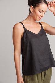A model wearing the Studio Linen Tank in colour Ebony (Black), from the front, cropped image