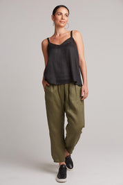 A model wearing the Studio Linen Tank in colour Ebony (Black), from the front, showing the whole outfit