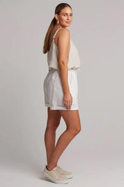 A model wearing the Studio Linen Short in colour Salt (White), from the back