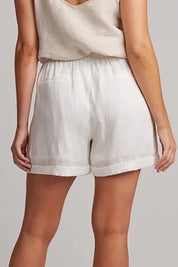 A model wearing the Studio Linen Short in colour Salt (White), from the back