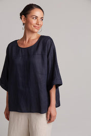 A model wearing the Studio Relaxed Top in colour Navy (Blue), from the front, cropped image