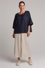 A model wearing the Studio Relaxed Top in colour Navy (Blue), from the front, showing the whole outfit
