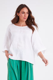 Model Madeline wearing size OneSize of the Studio Relaxed Top in colour Salt (White), from the front, cropped image