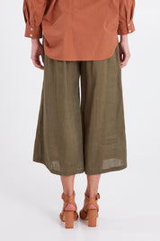 Model Madeline wearing size S of the Studio Crop Pant in colour Khaki (Green), from the back