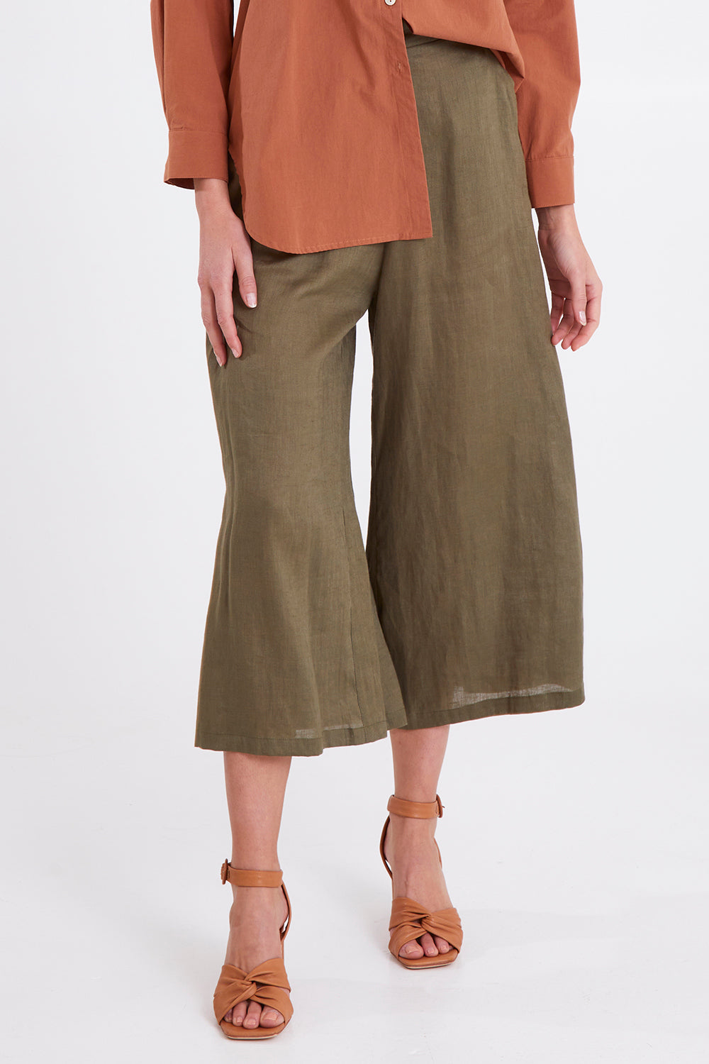 Model Madeline wearing size S of the Studio Crop Pant in colour Khaki (Green), from the front, cropped image