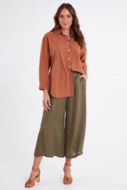 Model Madeline wearing size S of the Studio Crop Pant in colour Khaki (Green), from the front, showing the whole outfit