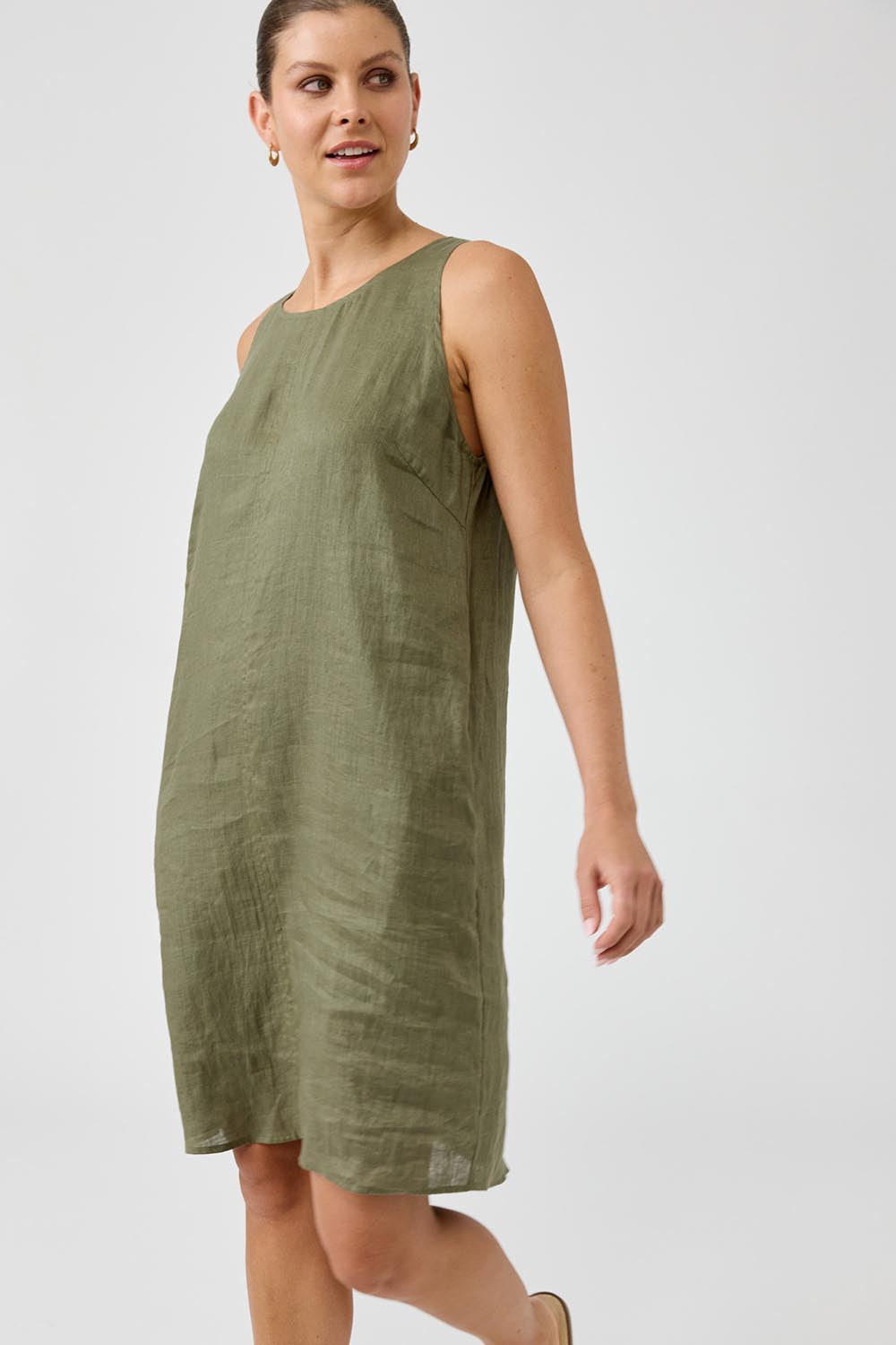 A model wearing the Studio Linen Midi Dress in colour Khaki (Green), from the front, cropped image