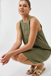 A model wearing the Studio Linen Midi Dress in colour Khaki (Green), from the front, showing the whole outfit