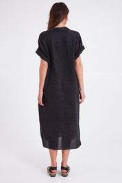 Model Madeline wearing size S of the Studio Shirt Dress in colour Ebony (Black), from the back