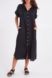 Model Madeline wearing size S of the Studio Shirt Dress in colour Ebony (Black), from the front, cropped image