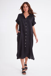 Model Madeline wearing size S of the Studio Shirt Dress in colour Ebony (Black), from the front, showing the whole outfit