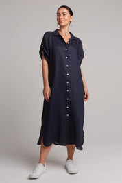 A model wearing the Studio Shirt Dress in colour Navy (Blue), from the front, showing the whole outfit