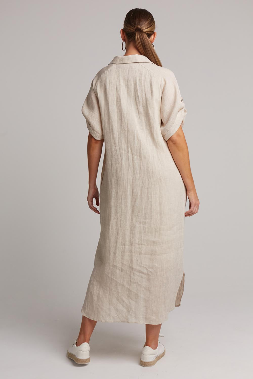 A model wearing the Studio Shirt Dress in colour Tusk, from the back