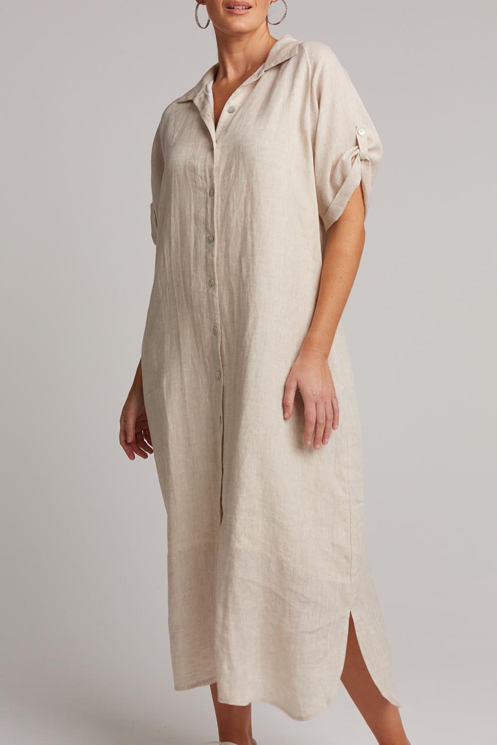 A model wearing the Studio Shirt Dress in colour Tusk, from the front, cropped image