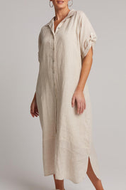 A model wearing the Studio Shirt Dress in colour Tusk, from the front, cropped image