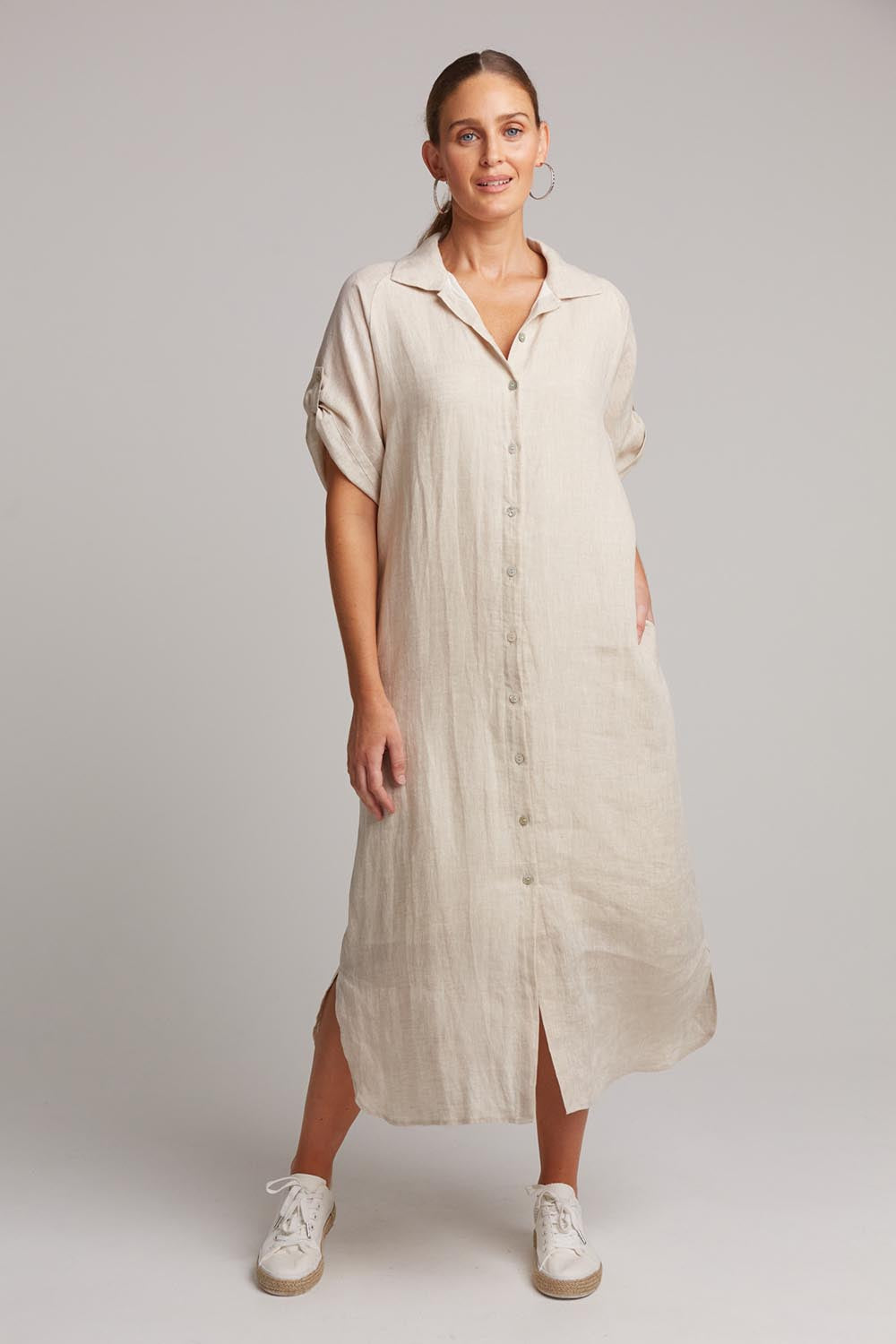 A model wearing the Studio Shirt Dress in colour Tusk, from the front, showing the whole outfit