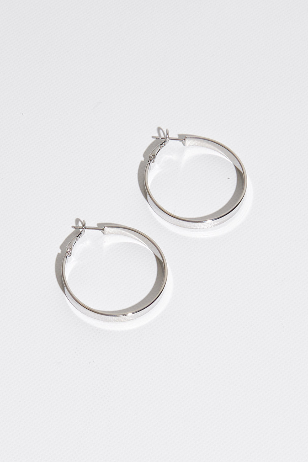 A model wearing size OneSize of the Daisy Hoop Earring in colour Silver (Metallics), from the front, showing the whole outfit