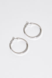A model wearing size OneSize of the Daisy Hoop Earring in colour Silver (Metallics), from the front, showing the whole outfit