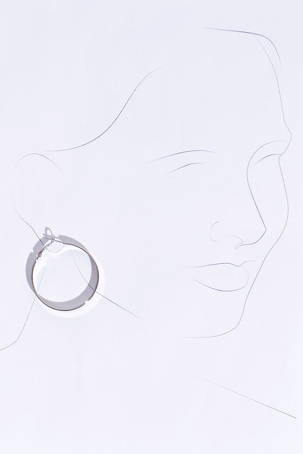 A model wearing size OneSize of the Daisy Hoop Earring in colour Silver (Metallics), from the front, showing the whole outfit