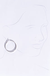 A model wearing size OneSize of the Daisy Hoop Earring in colour Silver (Metallics), from the front, showing the whole outfit