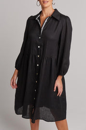 A model wearing the Studio Linen Midi Shirt Dress in colour Ebony (Black), from the front, cropped image