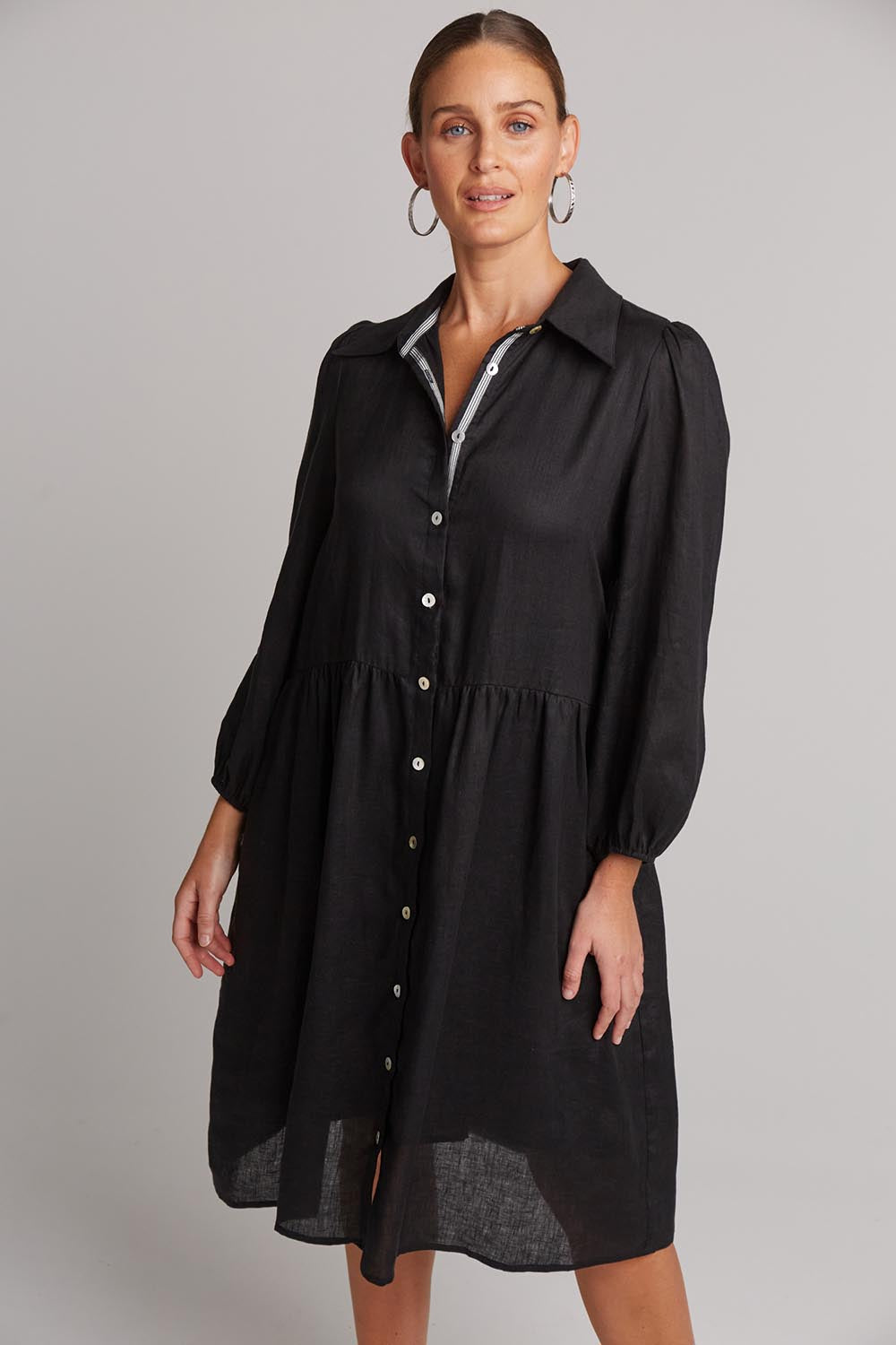 A model wearing the Studio Linen Midi Shirt Dress in colour Ebony (Black), from the front, cropped image