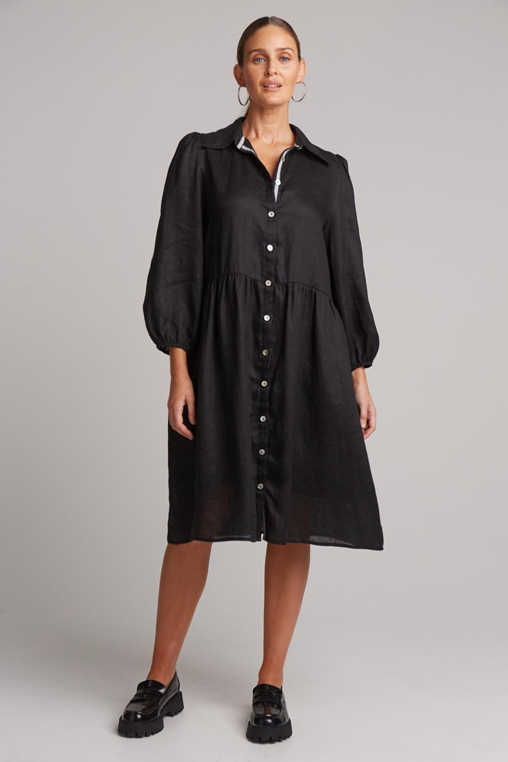 A model wearing the Studio Linen Midi Shirt Dress in colour Ebony (Black), from the front, showing the whole outfit