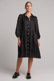 A model wearing the Studio Linen Midi Shirt Dress in colour Ebony (Black), from the front, showing the whole outfit