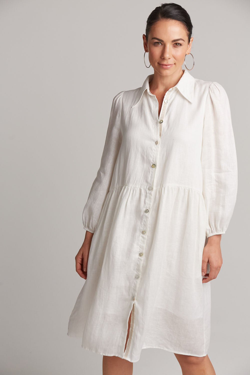A model wearing the Studio Linen Midi Shirt Dress in colour Salt (White), from the front, cropped image