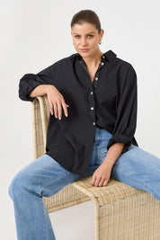 A model wearing the Studio Oversize Cotton Shirt in colour Ebony (Black), from the front, cropped image