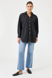 A model wearing the Studio Oversize Cotton Shirt in colour Ebony (Black), from the front, showing the whole outfit