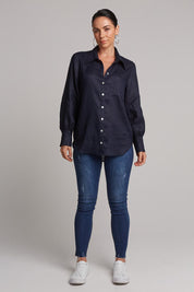 A model wearing the Studio Linen Shirt in colour Navy (Blue), from the front, showing the whole outfit