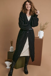 Model Emma wearing size OneSize of the Howie Cable Cardigan in colour Ebony (Black), from the front, showing the whole outfit