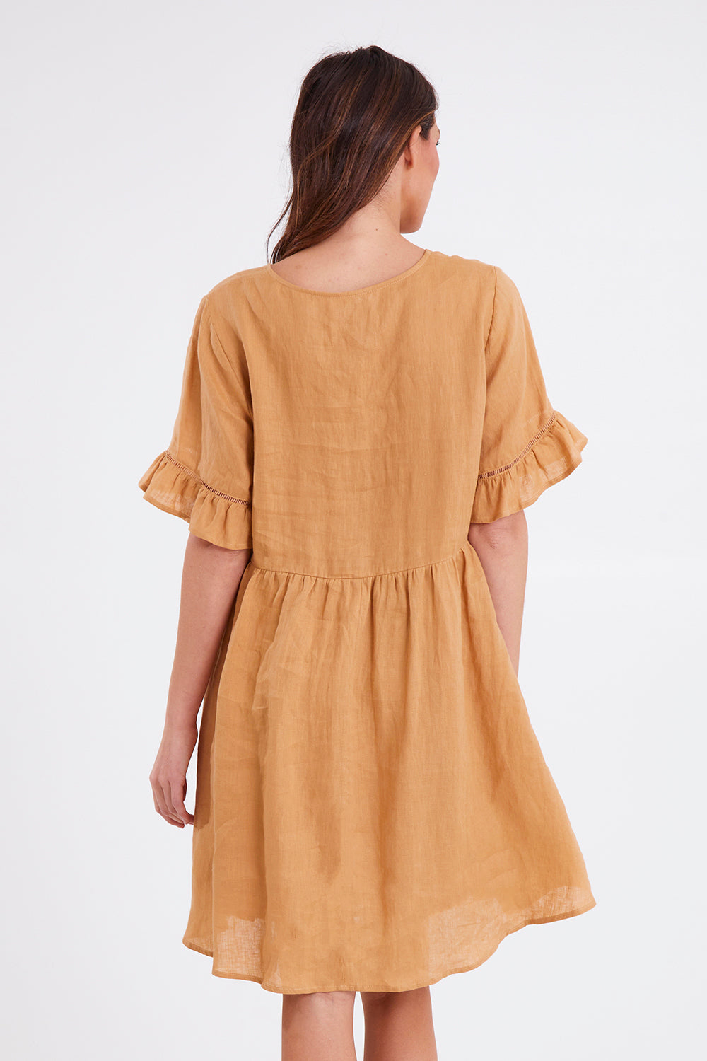 Model Madeline wearing size S of the La Vie Dress in colour Caramel, from the back