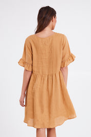 Model Madeline wearing size S of the La Vie Dress in colour Caramel, from the back