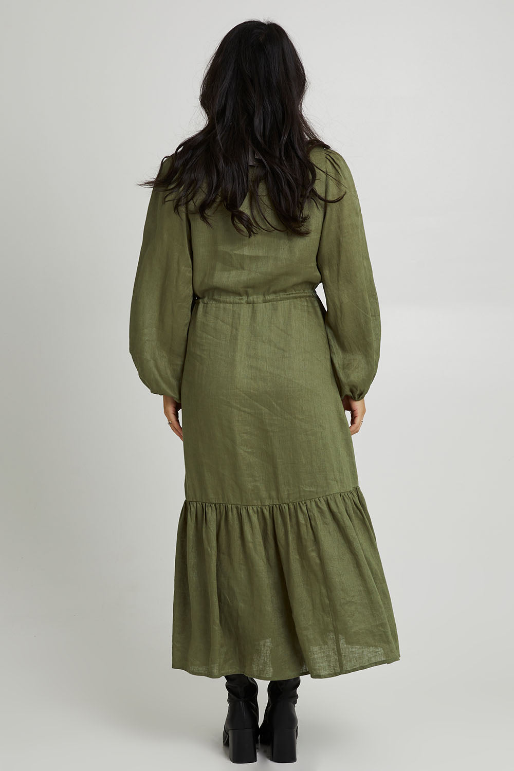 Model Katie wearing size S of the Nama Shirt Dress in colour Fern (Green), from the back